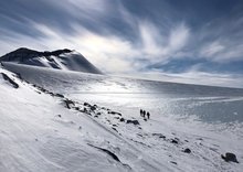 Scientists walking across a glacier